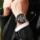 A stylish individual wearing a black jacket showcasing the Curren 8336 watch. The watch features a predominantly black design with accents of rose gold, adding a touch of sophistication to the ensemble.